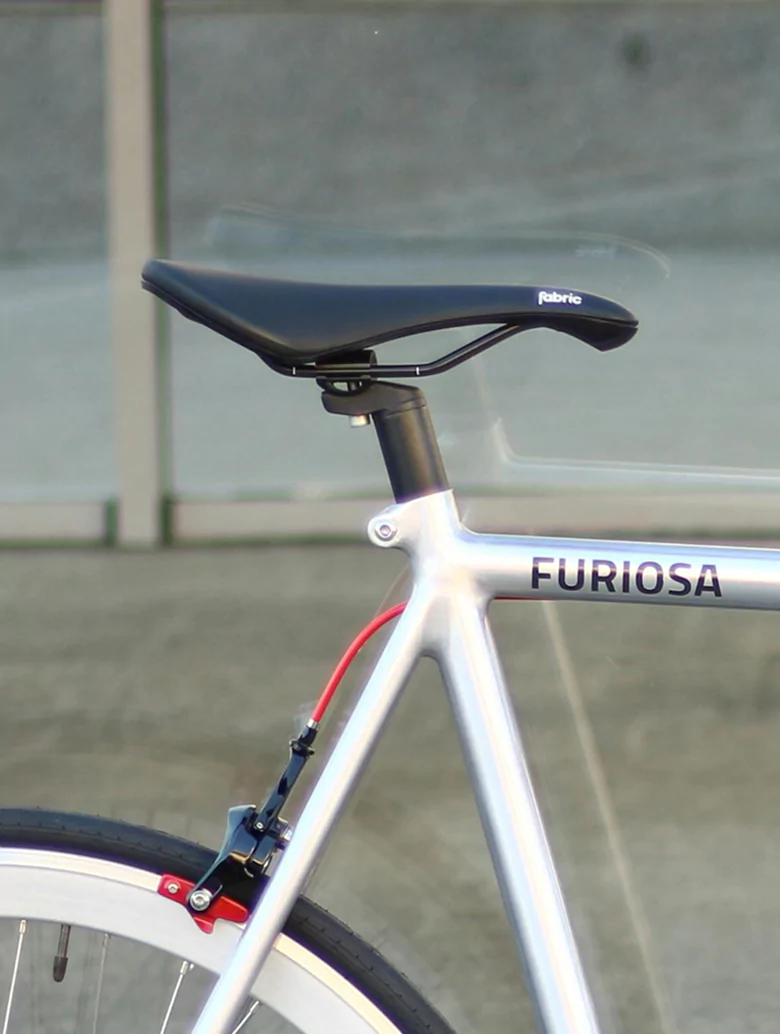 A bicycle featuring a white seat