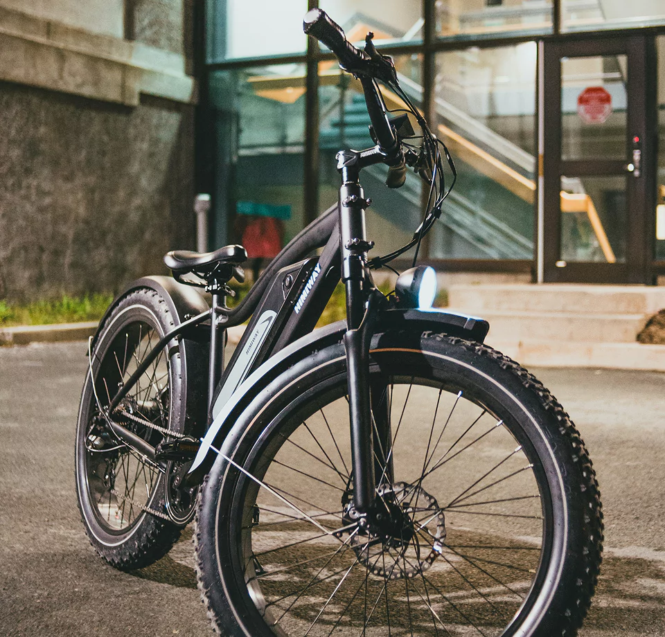 An electric bike parked in front of a building.
